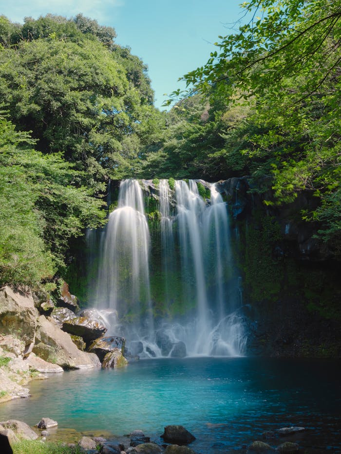 our-story-01 Beautiful waterfall cascading in a tranquil South Korean forest setting.