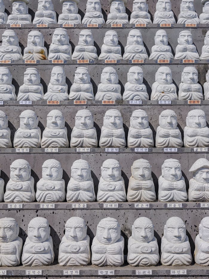 mission-02 Rows of stone monk statues in Seogwipo, Jeju-do, offering a serene and spiritual ambiance.